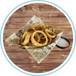 Onion rings in a basket with a side of ranch dressing